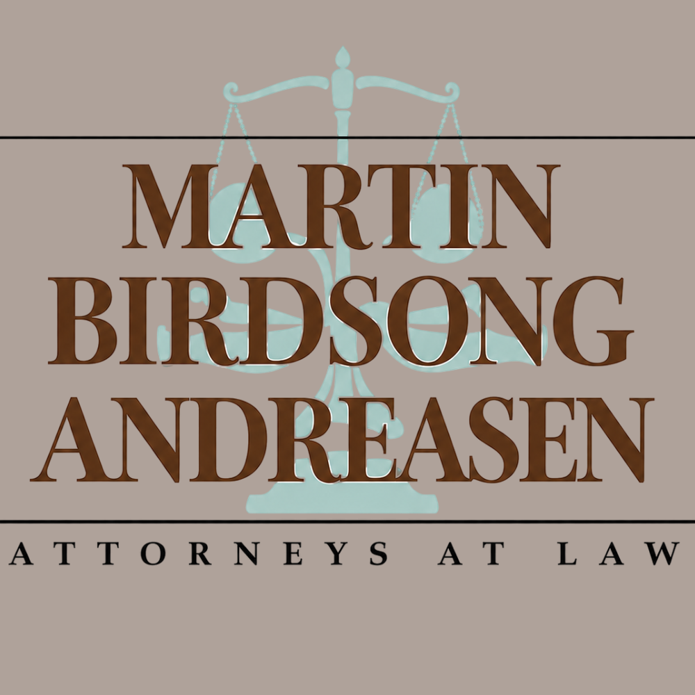 Law firm logo for Martin Birdsong Andreason Attorneys at Law, with teal scales of justice behind large brown serif text.